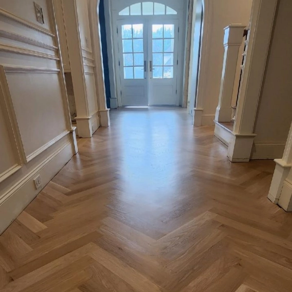 Chevron wood flooring in a bright home entrance