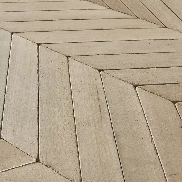 Close-up of rustic chevron wood floor planks.