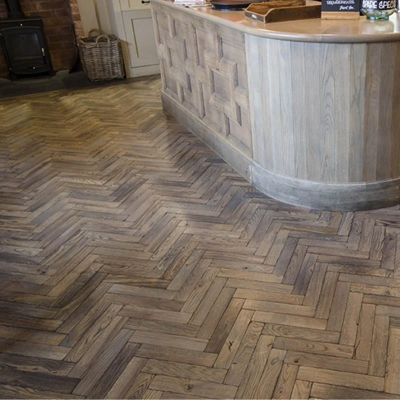 Grey oak herringbone flooring near a bar