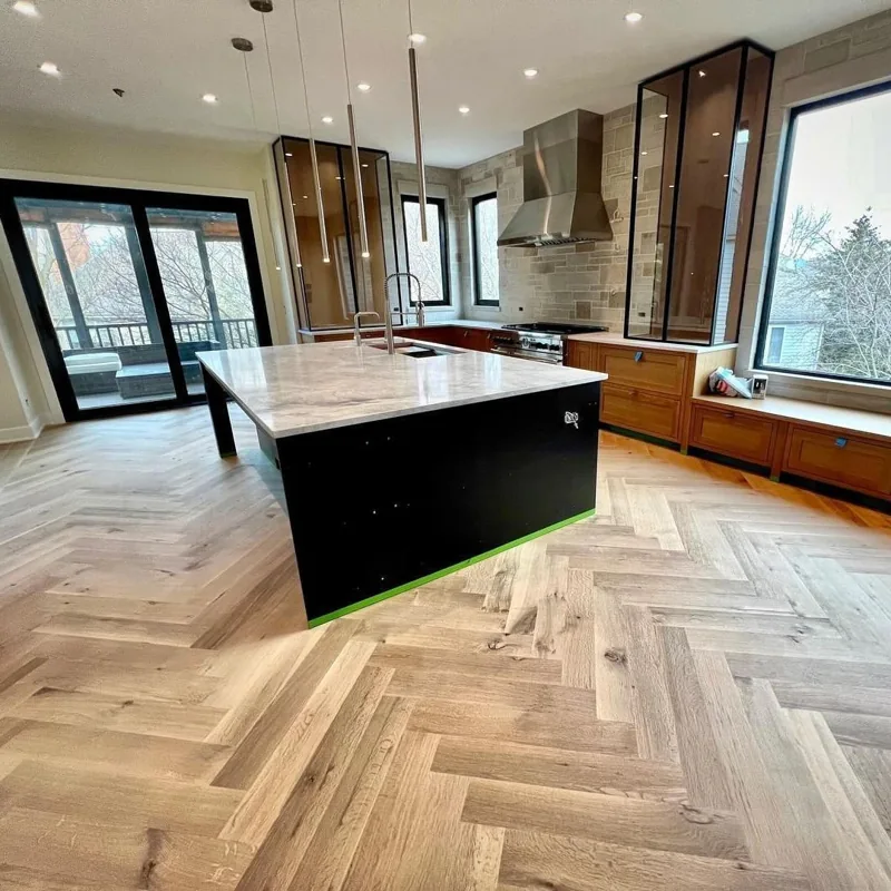 Light oak herringbone flooring in a modern kitchen.