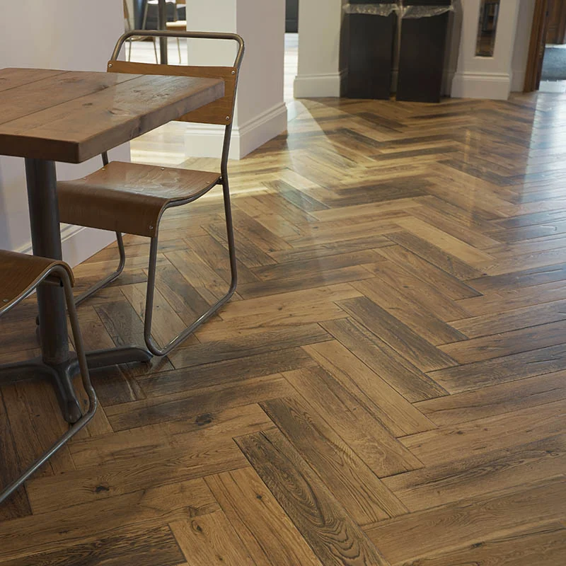 Rustic oak herringbone flooring in a cafe.